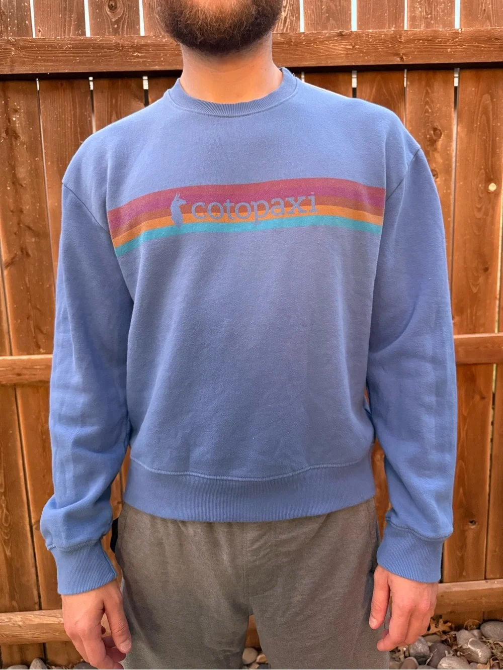 cotopaxi blue crewneck sweater with multicolor stripe logo